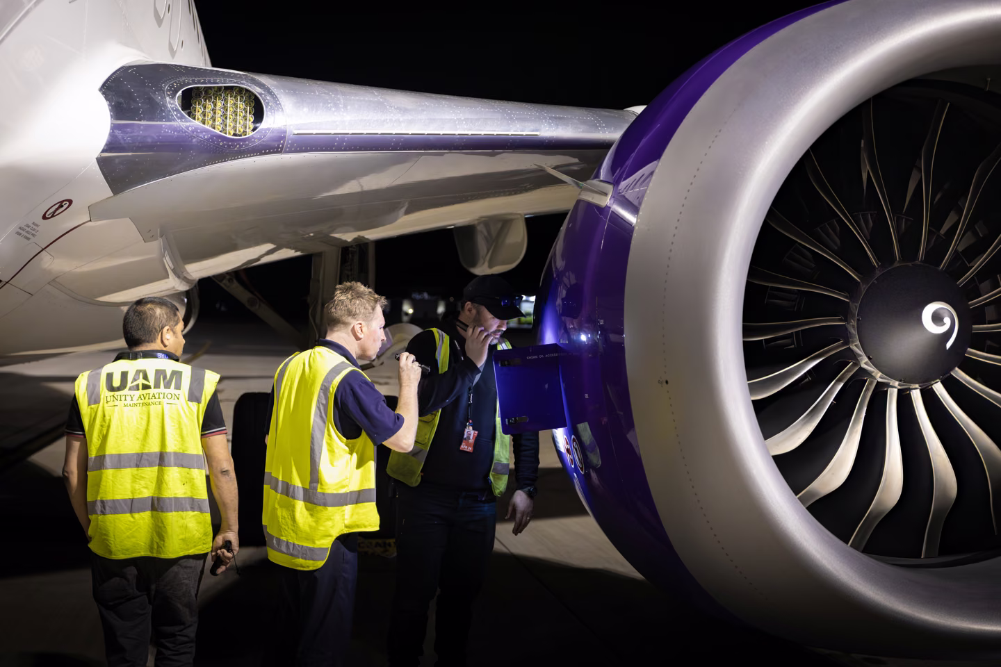 Aircraft engineers examining an aircraft engine during Sigma training