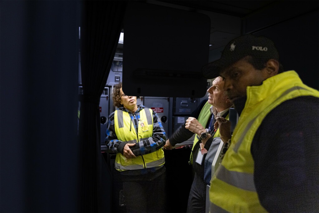 Aircraft Engineers inspect a panel in rear of 737